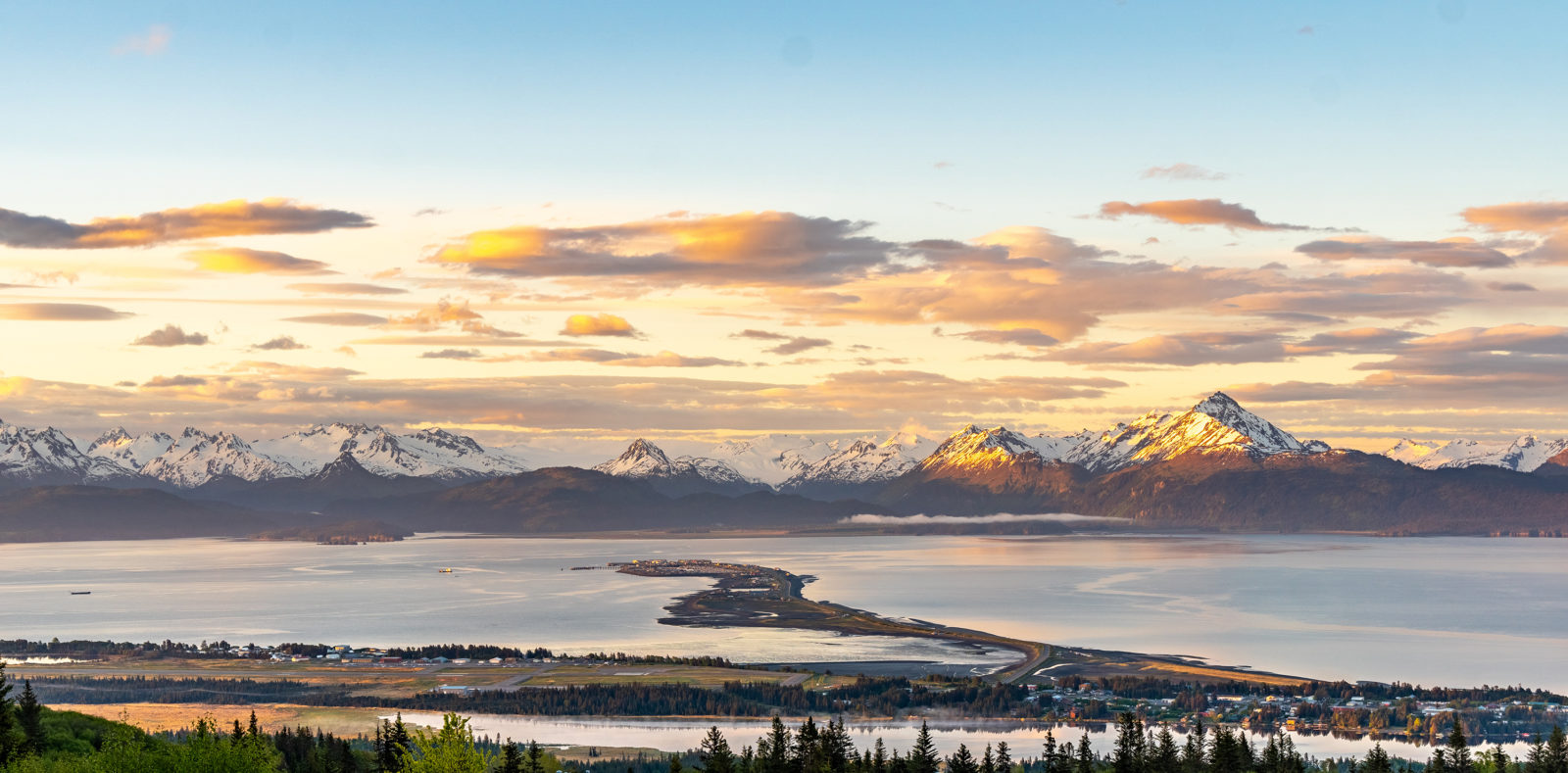 Homer Spit and Kachemak Bay as viewed from the top of Saddle Mountain. Kachemak Bay State Park, in the background provide access to hiking, backpacking and water sport.
